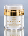 A clear cosmetic jar of Sapelo Infuse Illuminating Collagen Mask with a gold metallic band and gold lettering, set against a reflective gray background.