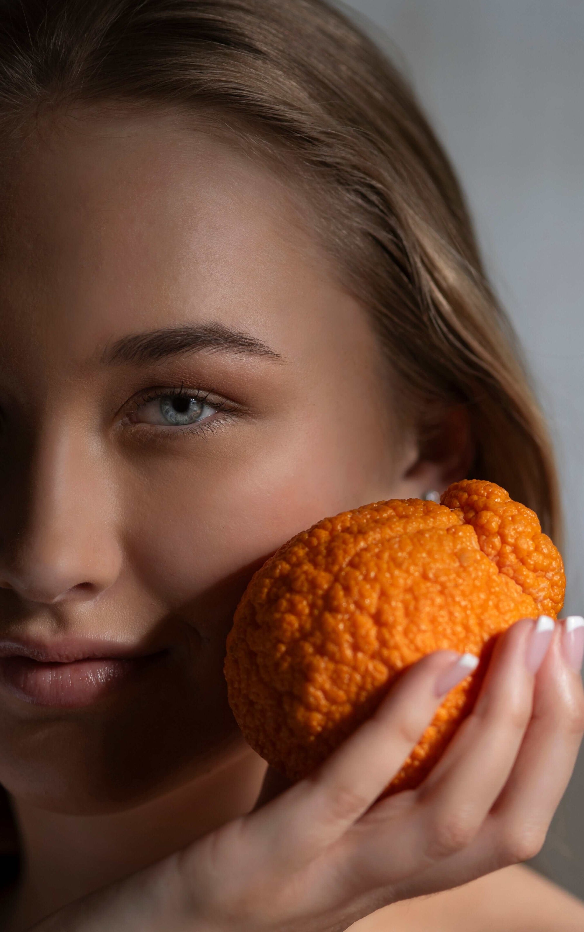 Model with Orange and Sapelo Skin Care - C Skin Activator - Vitamin C Serum