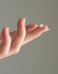 Model with Sapelo Skin Care Spring Tide Anti Aging Serum on tip of finger