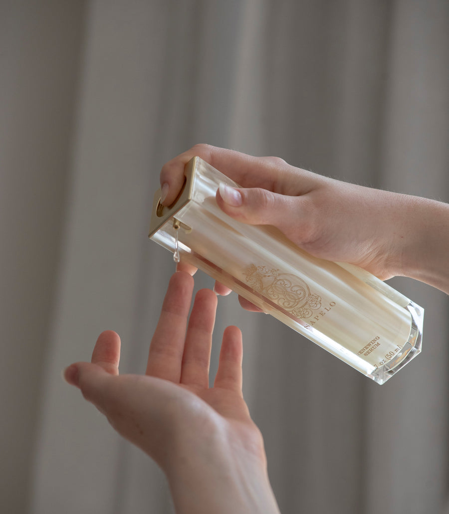 Person holding a rectangular crystal object against a neutral background