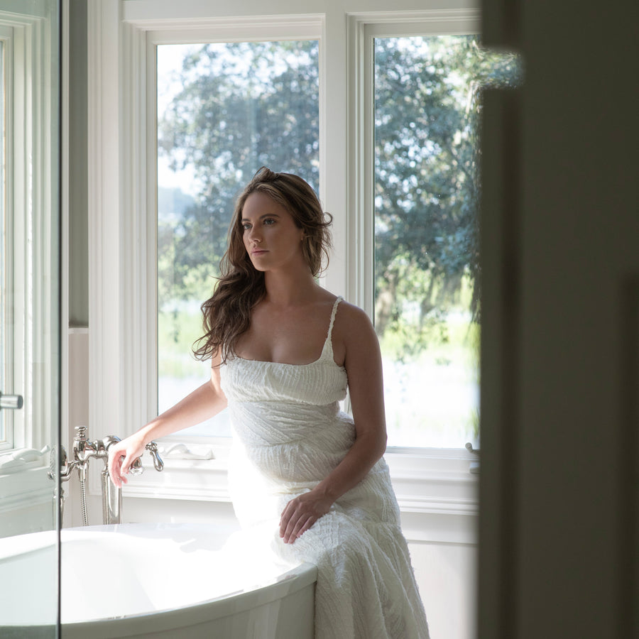 model in bathroom near garden tub