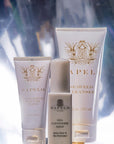 Sapelo skincare products including a cleanser, mask, and mist on a reflective surface with a blurred background.
