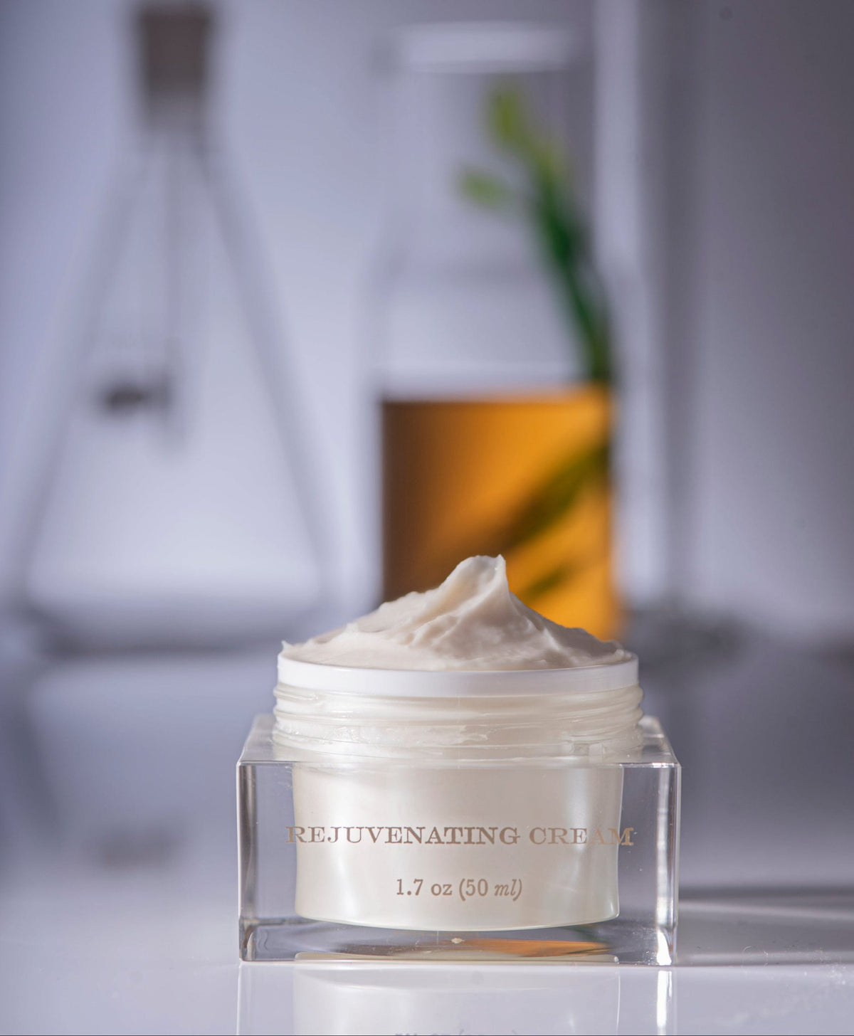Jar of rejuvenating cream with blurred scientific background