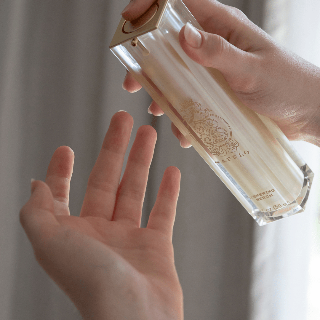 Sapelo Skin Care Renewing Serum - Model applying serum to hand for application 