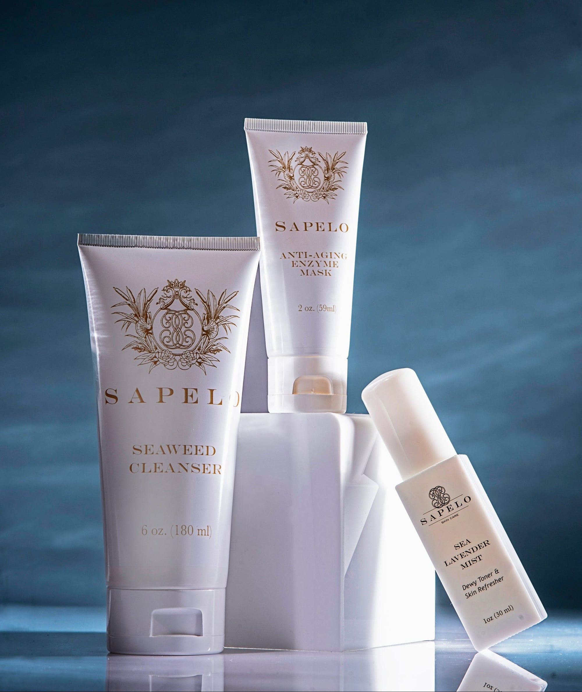 Sapel skincare products on a reflective surface with a dark blue gradient background