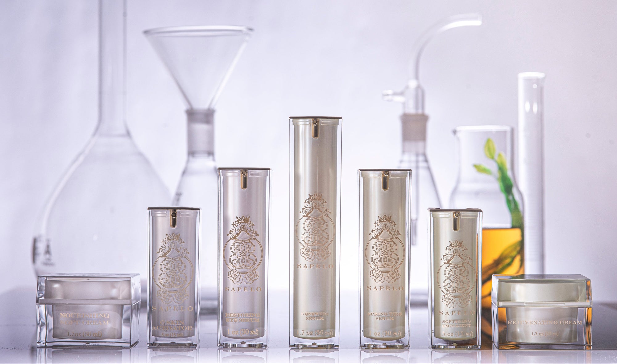 Set of silver skincare products with embossed designs on a white background